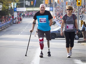 Bryan Cuerrier and Marie Andree Paquin make their way along Elgin Street at the start of the 10K race.