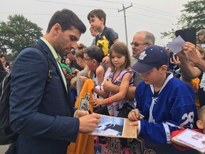 Leafs forward John Tavares signs an autograph for Nathan McEwan, 12, on 2018 Kraft Hockeyville game day in Lucan, Ont. Jennifer Bieman/Postmedia