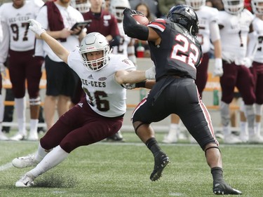 The University of Ottawa Gee-Gees' Kyle Rodger (36) tries to tackle the Carleton Ravens' Jalen Jana.
