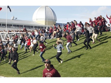 University of Ottawa Gee-Gees fans rush the field after the Gee-Gees won the Panda Game against the Carleton Ravens.