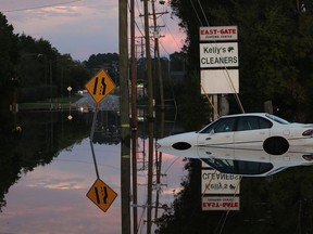 A car sits in a flooded parking lot on September 18, 2018 in Fayetteville, North Carolina. The Cape Fear river has reached its crest due to rains caused by Hurricane Florence which inundated the area with rain that caused concern for large scale flooding in the North Carolina and South Carolina area.