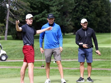 Thomas Chabot (L) celebrates making his putt as Mark Stone and Chris Wideman (R) of the Ottawa Senators look on.