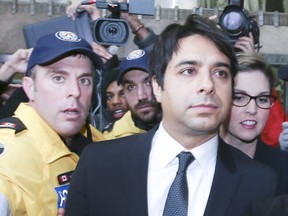 Jian Ghomeshi leaves College Park Courts on Wednesday, Nov. 26, 2014. (Veronica Henri/Toronto Sun/Postmedia Network)