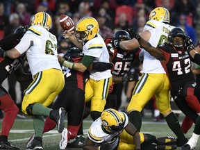 Edmonton Eskimos quarterback Mike Reilly loses control of the ball as he is sacked by Ottawa Redblacks linebacker Kyries Hebert during Saturday's game. (THE CANADIAN PRESS)