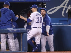 Blue Jays' Marco Estrada is congratulated at the dugout after leaving Monday's game against the Houston Astros. (GETTY IMAGES)
