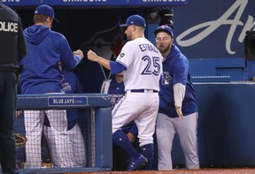 Blue Jays' Marco Estrada is congratulated at the dugout after leaving Monday's game against the Houston Astros. (GETTY IMAGES)