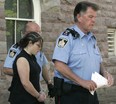 Accused Terri-Lynne McClintic is led in handcuffs from the Oxford courthouse after her first appearance. (Susan Bradnam/Postmedia File)