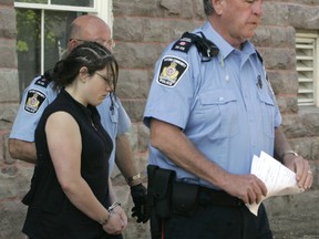 Accused Terri-Lynne McClintic is led in handcuffs from the Oxford courthouse after her first appearance. (Susan Bradnam/Postmedia File)