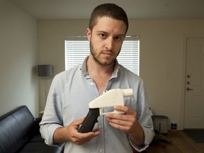 In this May 10, 2013, file photo, Cody Wilson, the founder of Defense Distributed, shows a plastic handgun made on a 3D-printer at his home in Austin, Texas.