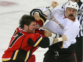 André Roy, then with the Calgary Flames, fights the Anaheim Ducks' George Parros during a game in February 2009.