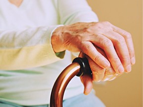 Elderly woman in nursing home, wrinkled hand with clearly visible veins holding walking quad cane. Old age senior lady arms with freckles lay on aid stick handle bar. Background, close up, copy space. 

LTC long term care senior citizen nursing home elderly old hand elder   Ageing health care  Old people  Palliative Assisted dying