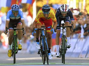 Ottawa's Michael Woods, left, Alejandro Valverde of Spain and Romain Bardet of France cross the finish line of the men's elite road race of the 2018 UCI Road World Championships in Innsbruck on Sunday.