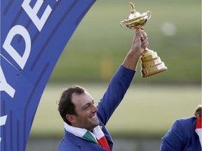 Italy's Francesco Molinari holds up the trophy after the European team won the Ryder Cup title at Le Golf National in Saint Quentin-en-Yvelines, France, on Sunday.