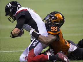 BC Lions defensive end Ivan McLennan (98) sacks Ottawa Redblacks quarterback Trevor Harris (7) during the first half of CFL football action in Vancouver, B.C., on Friday, Sept. 7, 2018.