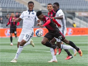 Fury FC's Azake Luboyera tries to squeeze past two Bethlehem Steel FC defenders during Sunday's match at TD Place stadium. Steve Kingsman/Freestyle Photography for Ottawa Fury FC