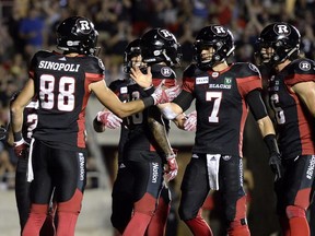 Redblacks receiver Brad Sinopoli (88) celebrates with quarterback Trevor Harris after scoring a touchdown against the Lions in a game in Ottawa in July.