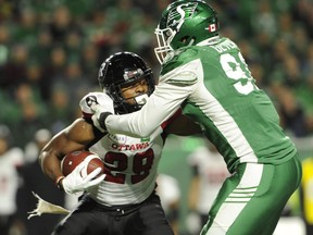 Ottawa Redblacks running back William Powell battles with Saskatchewan Roughrider defensive lineman Chad Geter during first half CFL action at Mosaic Stadium in Regina on Saturday, Sept. 15, 2018. THE CANADIAN PRESS/Mark Taylor