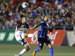 Ottawa Fury's Jadon Vilfort (45) kicks the ball away from Montreal Impact's Quincy Amarikwa (30) during second-half exhibition action in Ottawa on Friday, Sept. 7, 2018. (THE CANADIAN PRESS/PHOTO)