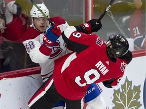 The Senators’ Bobby Ryan collides along the boards with Noah Juulsen of the Habs during Saturday night’s game. (THE CANADIAN PRESS)