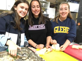 From left, Megan McCowan, 14, Anna Barbour, 15, and Alice Payne, 15, students at Glebe Collegiate, spent their day off school helping make lunches at the Parkdale Food Centre. Jacquie Miiller/Postmedia