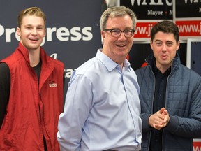 Jim Watson gathers with his campaign staff before he makes Sunday's announcement about a traffic safety plan that is part of his campaign platform. Wayne Cuddington/Postmedia