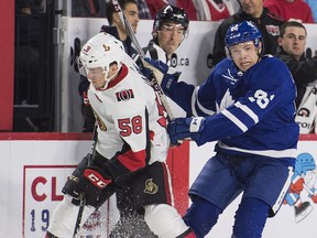 Toronto Maple Leafs’ Scott Pooley (right) collides with Ottawa Senators’ Maxime Lajoie during the NHL Rookie Showdown in Laval, Que., yesterday. (The Canadian Press)