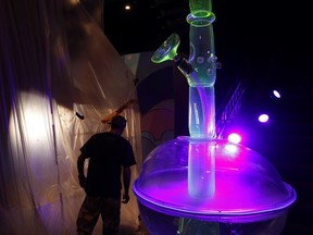 In this Tuesday, Sept. 18, 2018 photo, a man walks by a 24-foot-tall bong at the Cannabition cannabis museum in Las Vegas. The museum celebrating all things cannabis with displays that include a glass bong taller than a giraffe and huggable faux marijuana buds is the newest tourist attraction in Las Vegas.