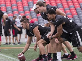 The Ottawa Redblacks line up for a snap during practice on Tuesday.
