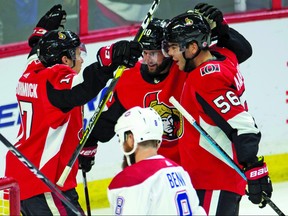 Montreal Canadiens defenseman Jordie Benn skates past Ottawa Senators left wing Tom Pyatt (centre) as he celebrates his goal with Magnus Paajarvi (right) and Max McCormick during first period NHL pre-season action Saturday September 29, 2018 in Ottawa. THE CANADIAN PRESS/Adrian Wyld