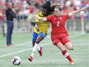 Brazil's Ludmila, left, and Canada's Allysha Chapman battle for the ball during first half soccer action in Ottawa on Sunday, Sept. 2, 2018.
