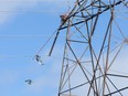 A Hydro worker clears debris from power lines in the Craig Henry neighbourhood on Saturday morning as residents in Ottawa's west end deal with the aftermath of the twister that touched down on Friday afternoon.