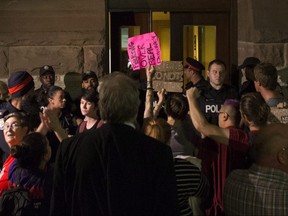 Protesters gather outside the doors of the Ontario legislature, demanding to be let in. (The Canadian Press)