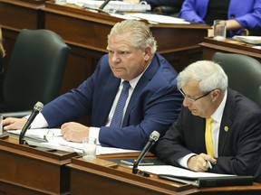 Premier Doug Ford, left, and Finance Minister Vic Fedeli during question period at Queen's Park on September 17, 2018.
