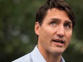 Prime Minister Justin Trudeau responds to questions from reporters after meeting with British Columbia Wildfire Service staff during a visit to the Prince George Fire Centre, in Prince George, B.C., on Thursday August 23, 2018. THE CANADIAN PRESS/Darryl Dyck