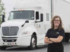 Truck driver Vivienne Carbonneau poses next to her rig in Vaudreuil-Dorion, Que., Monday, August 27, 2018. On a cloudy Monday in late August, Vivianne Carbonneau fires the ignition on her semi truck bearing the load of both an 80,000-pound trailer and a new job title hitched to her name just that morning: driving mentor. "If you learn from a woman, you always have that little voice inside that says, 'See, I can do it, I can do it, it‚Äôs possible,'" she said. "Any situation can be overcome."