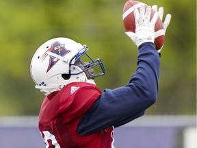 : MAY 29, 2017 -- Former Montreal Alouettes safety Chris Ackie catches the football during drill at training camp at Bishop's University in Lennoxville,