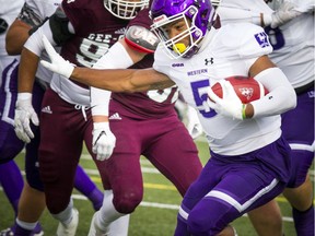 The Mustangs' Alex Taylor runs the ball against the Gee-Gees on Saturday, Oct. 13, 2018. He finished the game with 225 yards rushing.