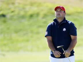 Patrick Reed reacts to a putt on the second during singles matches of the 2018 Ryder Cup at Le Golf National on Sunday.