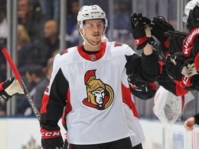 The Senators' Thomas Chabot is congratulated at the bench as he celebrates one of his two goals against the Toronto Maple Leafs.