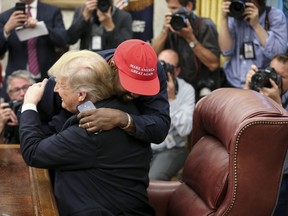 Rapper Kanye West hugs U.S. President Donald Trump during a meeting in the Oval office of the White House on Oct. 11, 2018 in Washington, D.C.