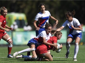 Olivia de Couvreur of Ottawa is tackled by Chloe Sanz of France during Canada's women's rugby sevens match at the 2018 youth Olympic Games on Monday at Buenos Aires.