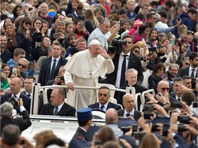 Pope Francis gestures towards the faithful as he arrives on the popemobile vehicle for the weekly general audience at St. Peter's square in the Vatican on Thursday.