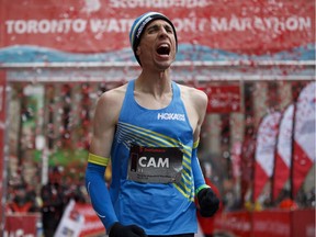 Cam Levins reacts as he crosses the finish line of the Toronto Scotiabank Waterfront Marathon. In winning the race, he also set a Canadian record for the fastest marathon ever, beating the 1975 mark set by Jerome Drayton.