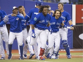 Toronto prospect Vladimir Guerrero Jr., middle, celebrates his game-winning home run against the St. Louis Cardinals in a 2018 pre-season contest in Montreal on March 27.