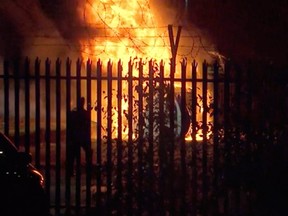 This image made from video shows a burning helicopter in a parking lot outside the King Power Stadium in Leicester, England shortly after a Premier League game on Saturday, Oct. 27, 2018.