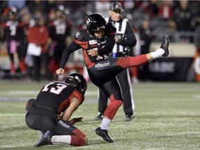 Redblacks kicker Lewis Ward (10) kicks his 40th consecutive field goal out of the hold by teammate Richie Leone during the second half of Friday's game against the Blue Bombers.