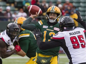 Eskimos quarterback Mike Reilly gets the ball out under pressure from the Ottawa Redblacks' Danny Mason during the first half in Edmonton on Saturday, Oct. 13, 2018.