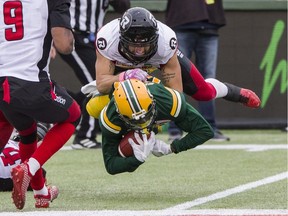 Redblacks defensive back Jean-Philippe Bolduc brings down Eskimos receiver Bryant Mitchell