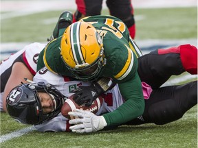 Redblacks quarterback Trevor Harris is sacked by Eskimos defensive lineman Alex Bazzie during the second half of last Saturday's game in Edmonton.