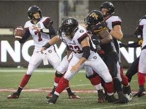 Redblacks quarterback Trevor Harris prepares to throw a pass against the Ticats during the first half of Saturday's game in Hamilton.